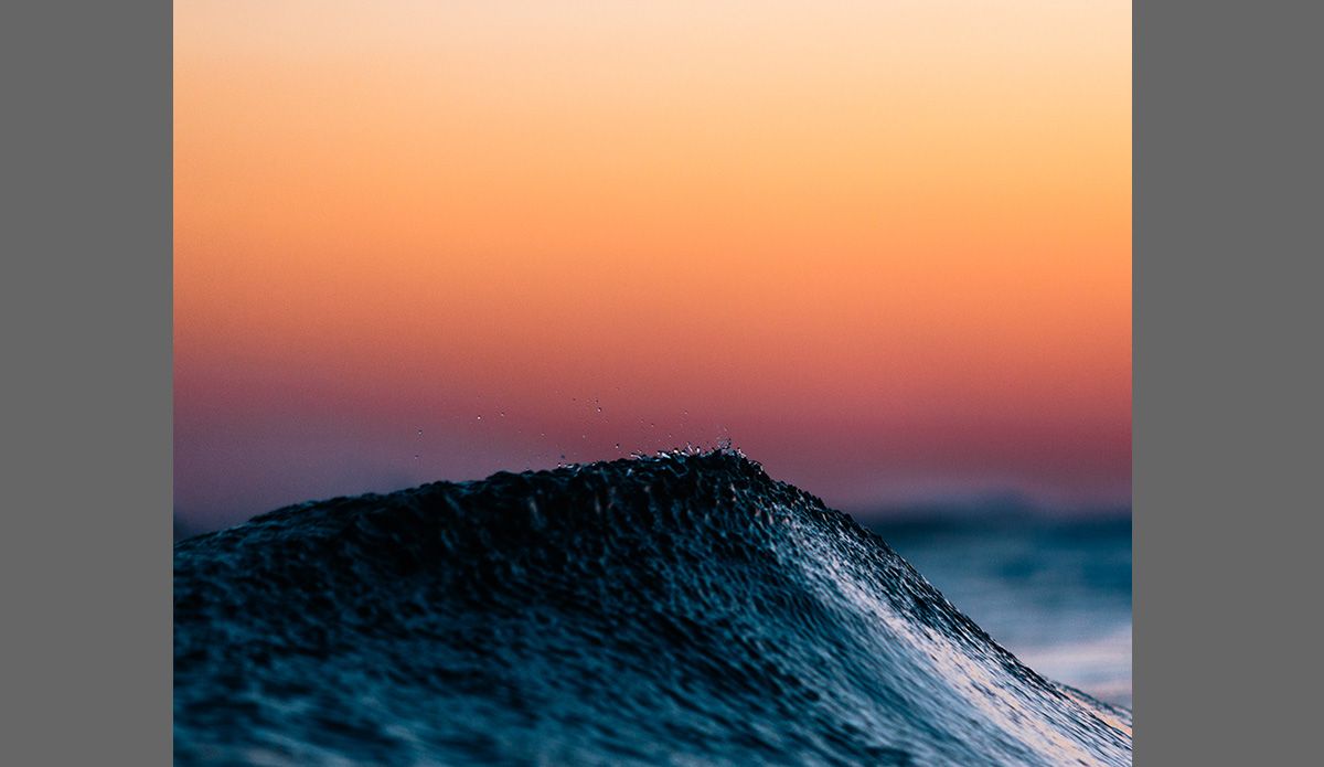 Dollop- Again, the fine detail of this image is what makes it interesting to me. I have photos of perfect waves and then I have images that really make me say \"Wow, that\'s something none of us ever see, we may get a moment of it now and then but when you\'re out surfing, you\'re not looking at droplets be blown off the top of a wave from a cool offshore summer breeze.\" Photo: <a href=\"https://www.clarkography.com/\" target=_blank>Matt Clark</a>