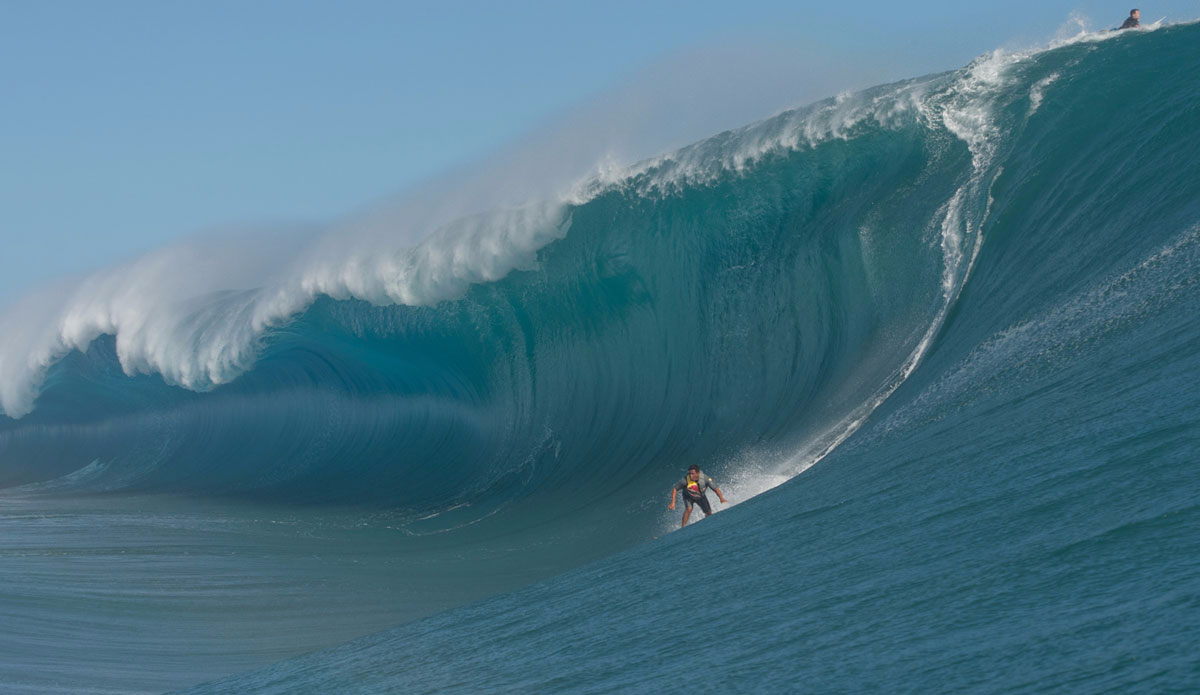 Raimana at the foot of a monster. Photo: <a href=\"https://www.timmckennaphoto.com/\">Tim McKenna</a>