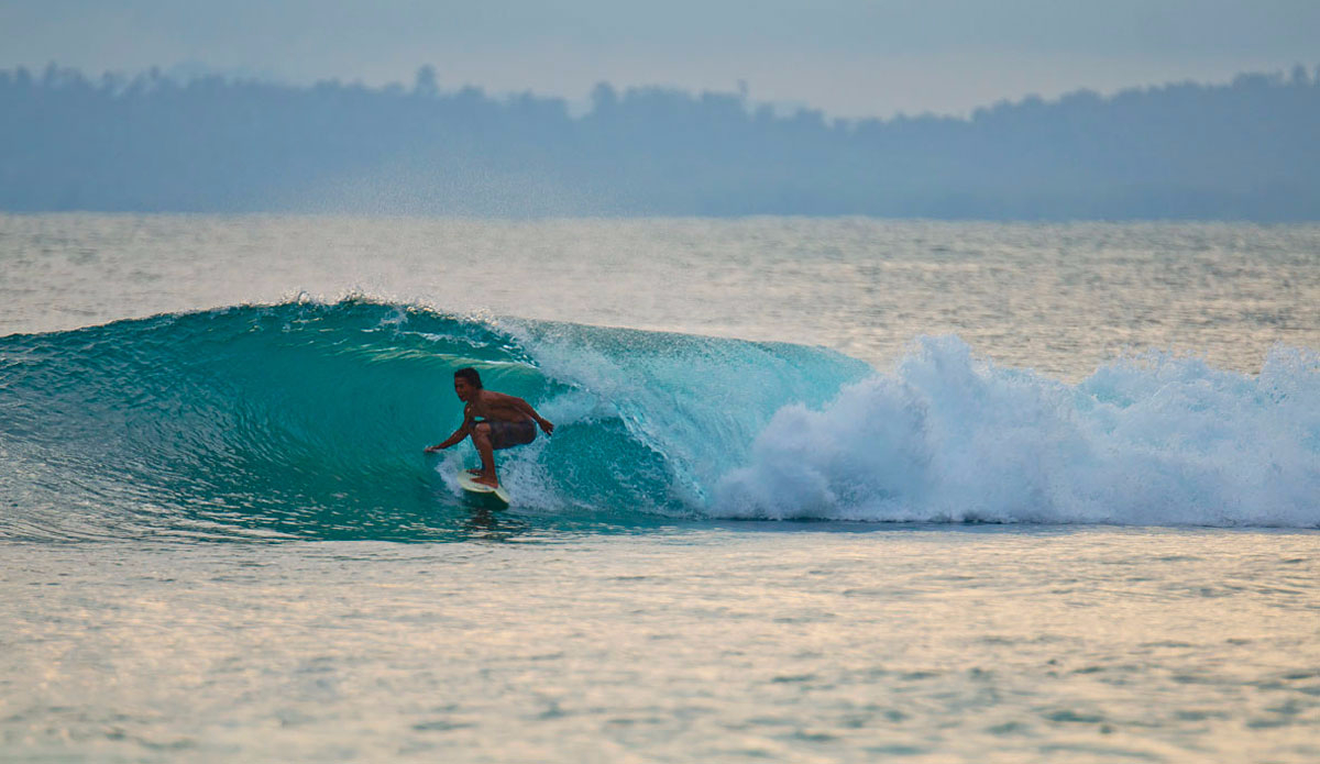 Aan, a local, finding a little tube. Photo: <a href=\"https://www.shootingdownthebarrel.com/\">Nico Palacios</a>