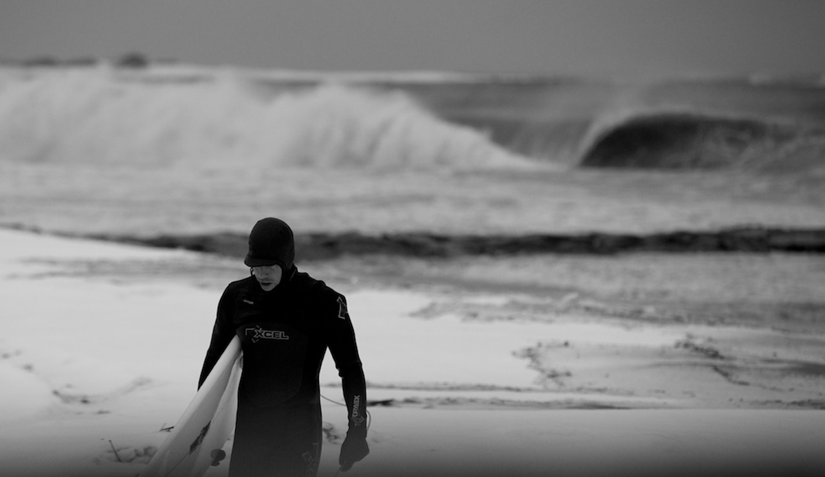 This is my friend Mike Moran walking up the beach after a session he had in the thick of a Nor\'easter on the eve of Valentines Day in New York.  This was the first image I had used in a feature.  ESM picked it up for their Valentines Day feature.  I really like how it captures the mood of the day; it was heavy, windy, snowy, and cold and you can really imagine how those elements take a toll on the body when one decides to brave those conditions to score perfect tubes.  East coast winters are pure gold. Photo: <a href=\"https://www.mgvphotography.com/\">Michael Vericker</a>