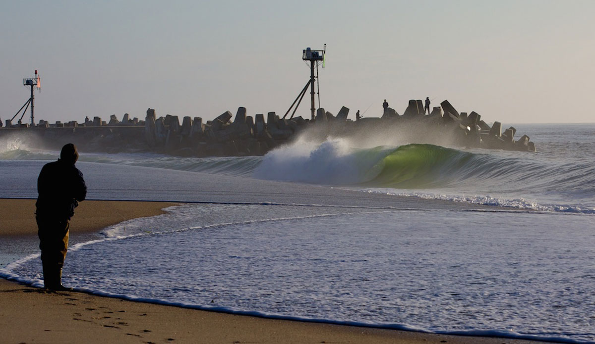 On this morning it was just me and the fishermen. That is until I gave Ben Currie a call to come join me.   I really love this shot and consider it one of my best from land.  Just the whole scene, the light, the water laying up on the beach from the initial waves in the set, and the way that guy is leaning over almost in awe of that backlit barrel the same way I would react to seeing a wave like that.  It encapsulates why I wake up before the Sun rises when the waves are good. Photo: <a href=\"https://www.mgvphotography.com/\">Michael Vericker</a> 