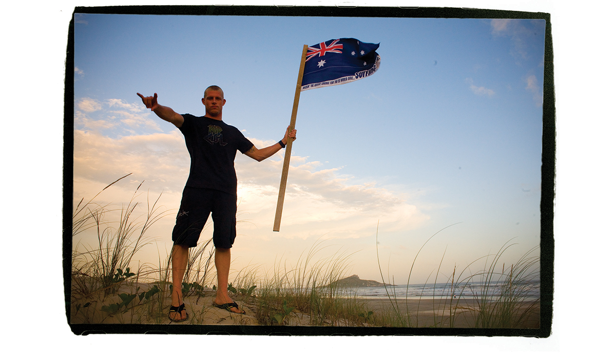\"His first world title in 2007, and I brought this flag, and I had the idea of him on top of the hill for Australia, like a battle. So he gave me ten minutes and we went across the sand dune in Brazil and we shot that photo, and I thought it really summed it up: Australia taking ground.\" Photo: <a href=\"https://t-sherms.com/\" target=\"_blank\">Steve Sherman</a>