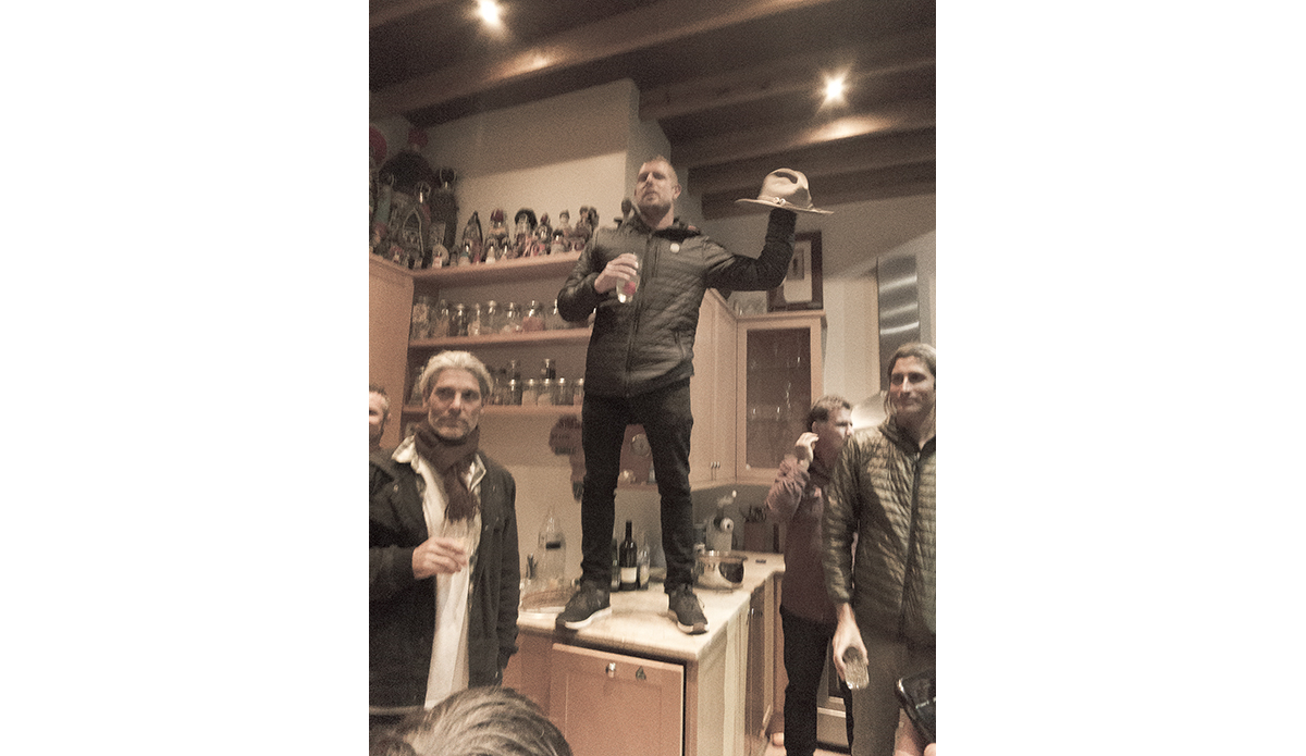 \"That\'s the day he won J-Bay again the year after the shark, and he had won. He had just won. The hat in his hand is my hat, which he stole again. He\'s up on the table wearing my hat giving a speech, and right after that he jumps down and Kelly walks in the kitchen, and Mick charges across the kitchen full speed and tackles him full speed on the floor full jiu-jitsu wrestling on the beer-soaked floor. That\'s Mick in a nut shell, and he just goes for it.\" Photo: <a href=\"https://t-sherms.com/\" target=\"_blank\">Steve Sherman</a>