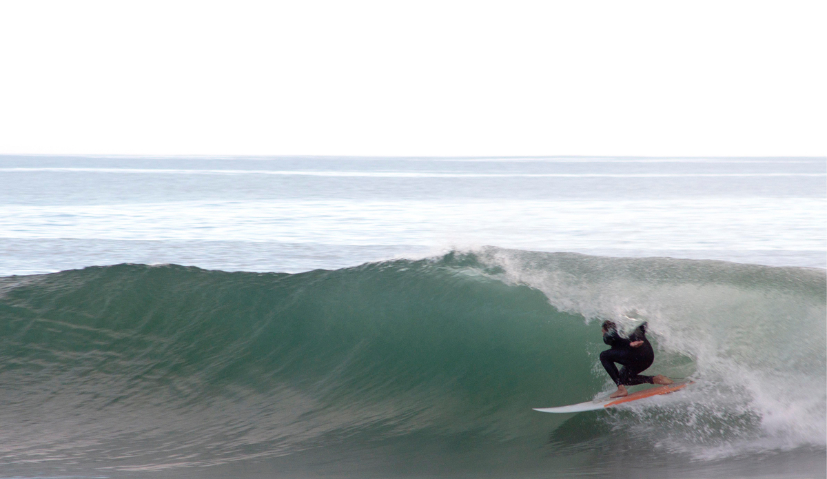 Johnny Mccann tucks into a glassy one for a moment of solitude amongst the masses. Photo: <a href=\"https://www.milesjackler.com\"MilesJackler.com</a>