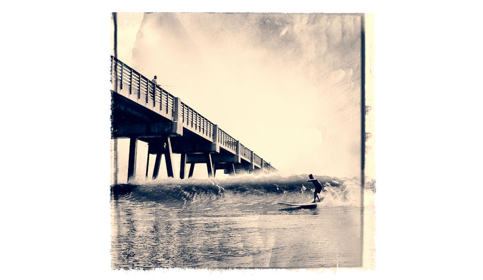 This images is iconic because it depicts a local Mitch Kaufmann, (dubbed the mayor of Jax Beach, due to him knowing everyone, and having done a lot for our local surf community) aiming to shoot The Jacksonville Beach Pier on his 12 foot board. The pier has always been a wave magnet, and the waves here have produced a wealth of talent throughout the years. We have a very strong surf community here. Photo: <a href=\"https://www.marksainwilson.com/?splash=1\" target=_blank>Mark Wilson</a>