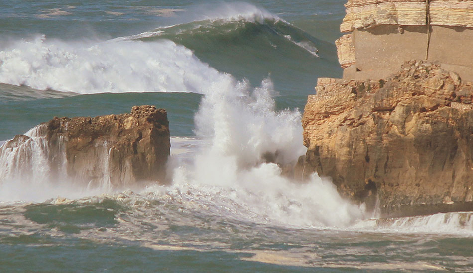 Garrett McNamara rides again between the rocky canyon. Photo: <a href=\"https://www.theinertia.com/author/jose-pinto/\">Jose Pinto</a>