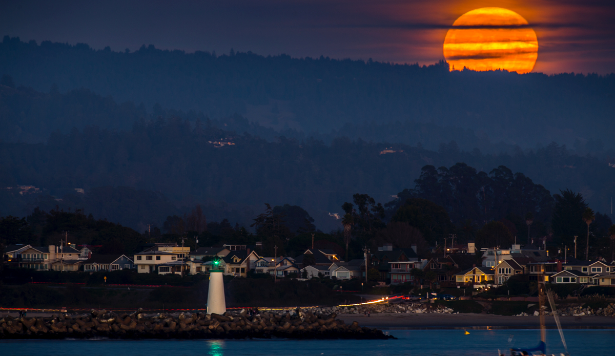 The moonrise over the harbor in Santa Cruz as seen from Steamer Lane.