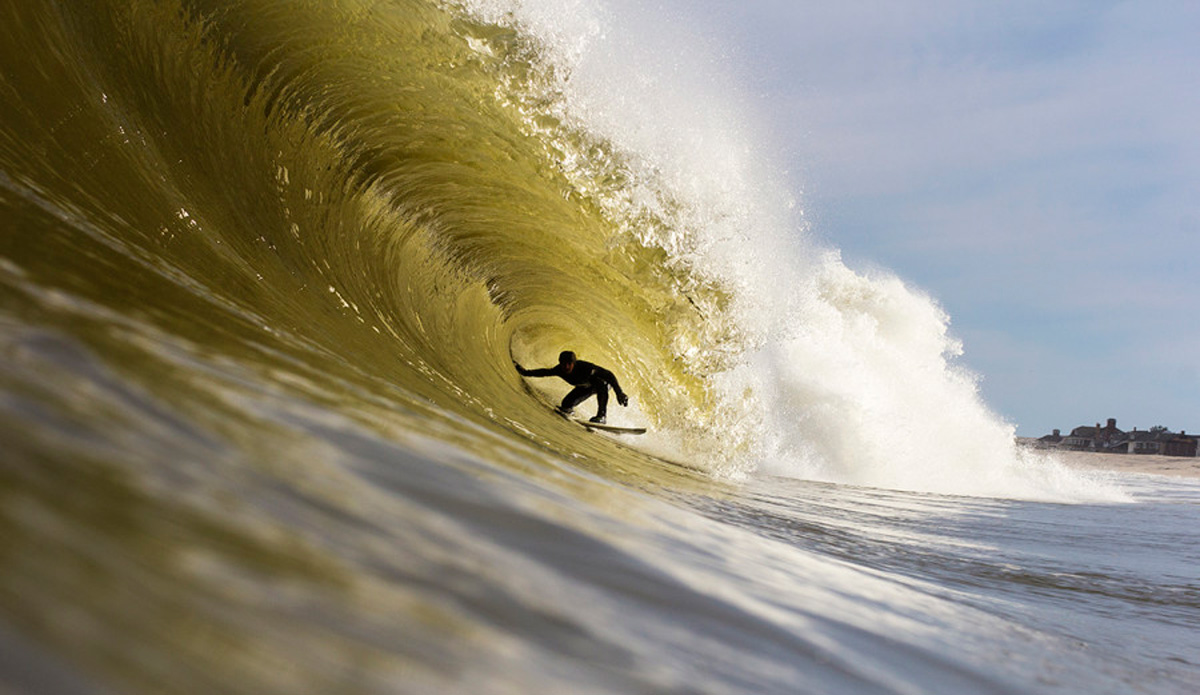 Sam Seeland locked into a barrel at golden hour as I struggled to swim against the current. Photo: <a href=\"https://www.davenilsenphotography.com/\">David Nilsen</a>