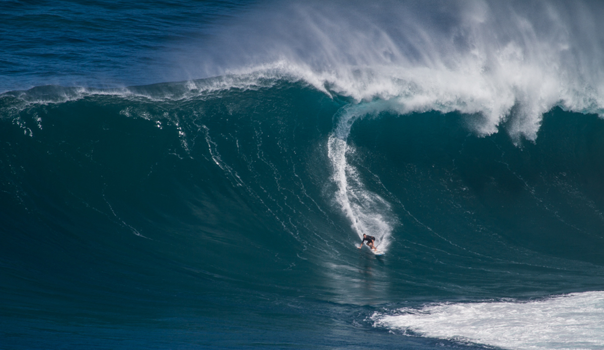Twiggy on a Pe’ahi bomb. This swell was unreal and the level of performance just keeps getting higher and higher out there. Photo: <a href=\"https://www.nickricca.com\">Nicks Ricca</a>