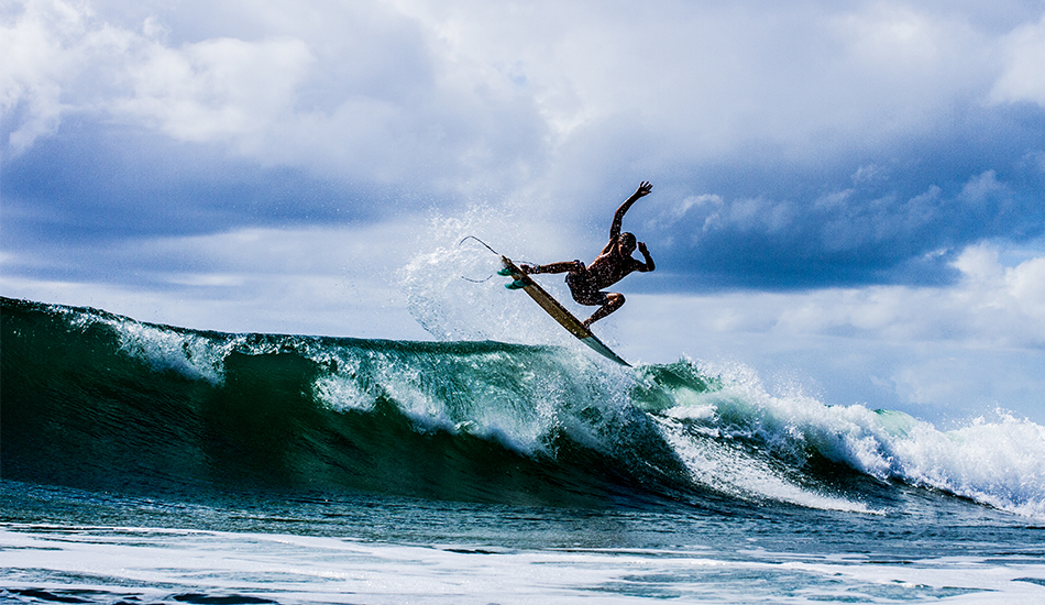 Jack Reginato throwing fins high. Photo: <a href=\"https://www.thetypewriterboy.com/\"> Nico Beighton</a>
