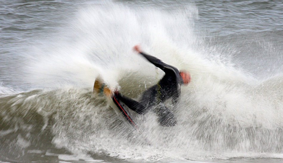 Ryan Rhodes. A longtime member of the local boogie tribe. Ryan Rhodes has always set the example, in and out of the water! A 30th of a second flip turn. Image: Mickey McCarthy