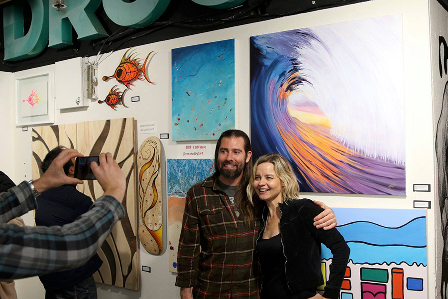 Ocean Stoke Artist Breanne Custodio stands for a photo with her artworks. Photo: Jerry Jaramillo