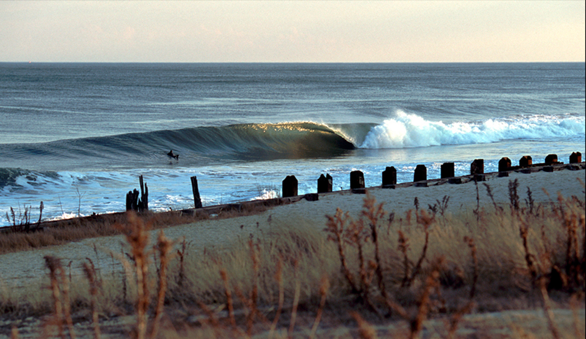 February 2002 - On the way back to Puerto Rico from a snowboarding trip in Jackson Hole, Wyoming I lucked into a classic winter swell in New Jersey and captured this lone surfer paddling through the lineup at a spot known as Stinky\'s, all this after my first cold water surf session in nearly a decade. Image: <a href=\"https://stevefitzpatrick.com/\" target=\"_blank\">Fitzpatrick</a>  