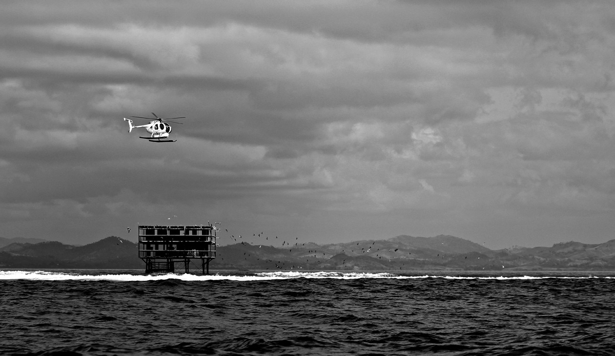 For those folks with a few bucks lyin\' around, you can fly into Tavarua via helicopter and check Cloudbreak on the way. Photo: <a href=\"https://petemilnesproductions.com/\">Pete Milnes</a>