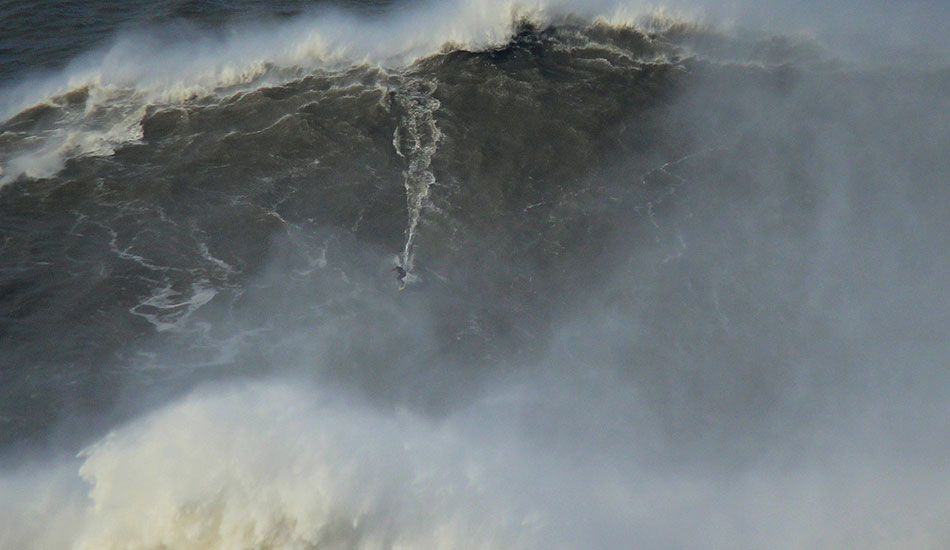 Charging down the face of a Nazaré beast. Photo: <a href=\"http://www.theinertia.com/author/jose-pinto/\">Jose Pinto</a>