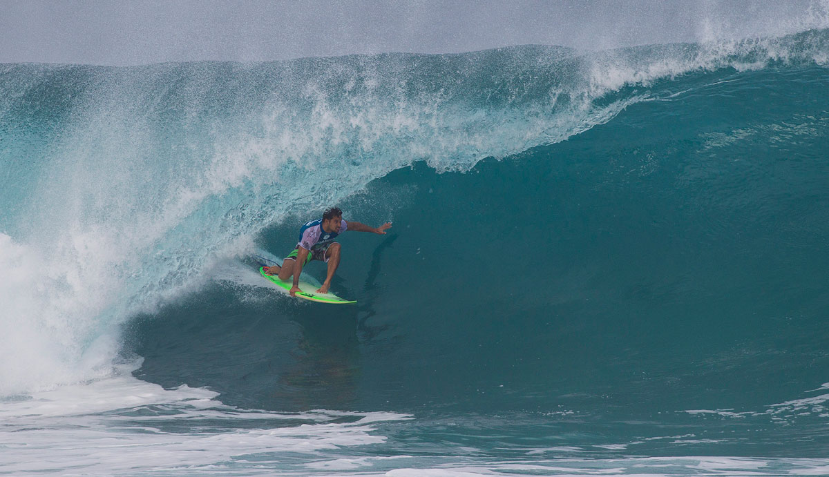 Michel Bourez of Tahiti (pictured) winning his Round 2 heat after snapping his surfboard during the Billabong Pipe Masters on Saturday December 13, 2014. In the challenging conditions Bourez defeated wildcard Makai McNamara (HAW) with a heat total of 8.33 points (out of a possible 20.00). Photo: <a href=\"https://www.aspworldtour.com/\">ASP</a>/Masurel