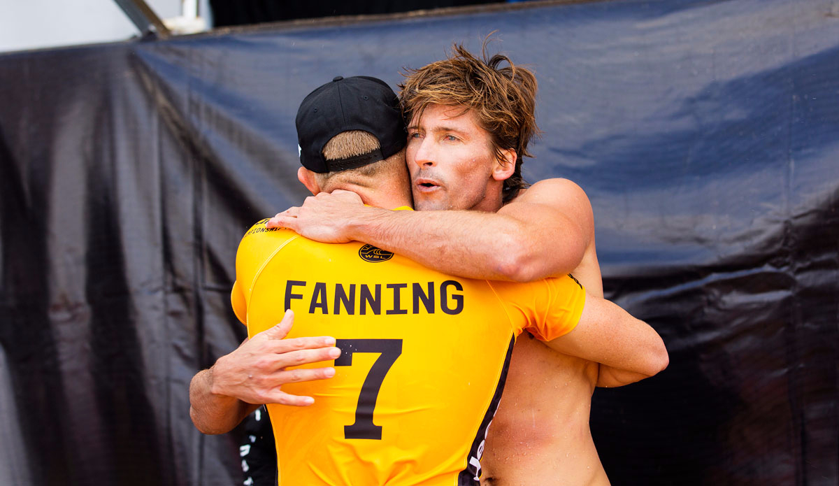 Bruce Irons of Hawaii hugs Mick Fanning of Australia after Fanning defeated the Hawaiian in their Round 1 heat at the Billabong Pipe Masters at Pipeline, Oahu, Hawaii on Thursday December 10, 2015. 
Photo: <a href=\"http://www.worldsurfleague.com/\">WSL</a>/<a href=\"https://www.instagram.com/kirstinscholtz/\">Scholtz</a>