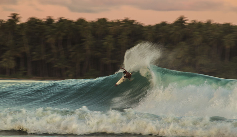 This was a last minute call for Tai \" Buddha \" Graham to come up to Nias for this swell. It sure did pay off for him. Nias is such an amazing place to shoot. The light in the morning is amazing from the water and then the afternoon light is pure gold. Speed blurs are one of my passions to shoot and here, with such a cool backdrop and the color of the sky, it makes it such pleasure to shoot. Photo: Brad Masters
