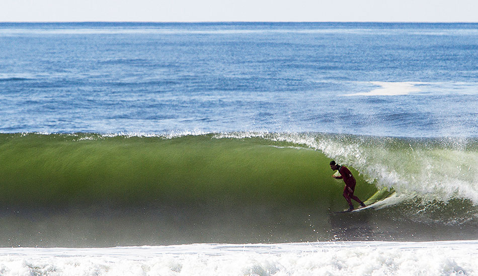 Aaron Gold is big-wave charger from the North Shore of O’ahu. This dude started surfing legitimate Waimea Bay in his early teens. No joke. Now he paddles into Cortes Bank, Pe’ahi, and the heavy outer reefs near his home on the North Shore. Here he is in some freezing cold water and a “little” barrel. Photo: <a href=\"https://markmcinnis.com/\">Mark McInnis</a>