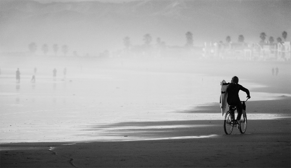 A kid called dirty-boy biking home at low tide. Photo: <a href=\"https://www.rickyjlesser.com/\" target=_blank>Ricky Lesser.</a>