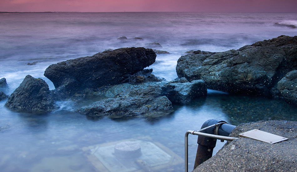 The pool at Blackhead beach is surrounded by beautiful rockpools, and then there\'s a pump right in the middle of it all. Photo: <a href=\"https://www.twhyphotography.com\">Tyhe Reading</a>