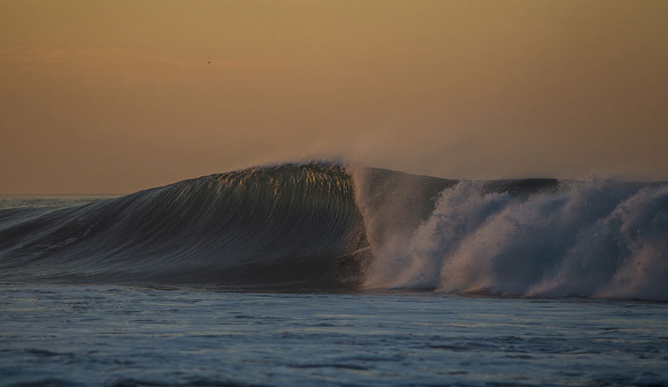 At first light, an unknown surfer digs into a throaty barrel at Keramas. Photo: Mick Curley