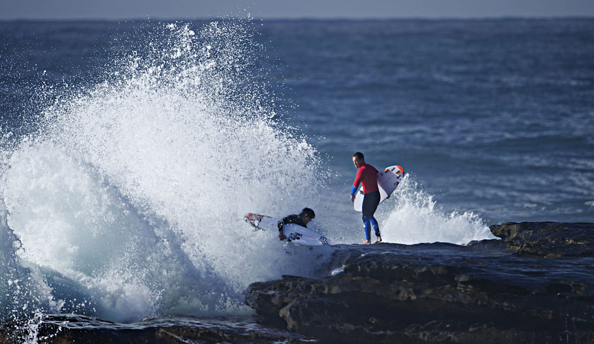 Bruce Irons (L) and Koby Abberton (R) chased out by the whitewash. Photo: <a href=\"https://www.redbullsignatureseries.com/cape-fear-2014\">Red Bull</a>