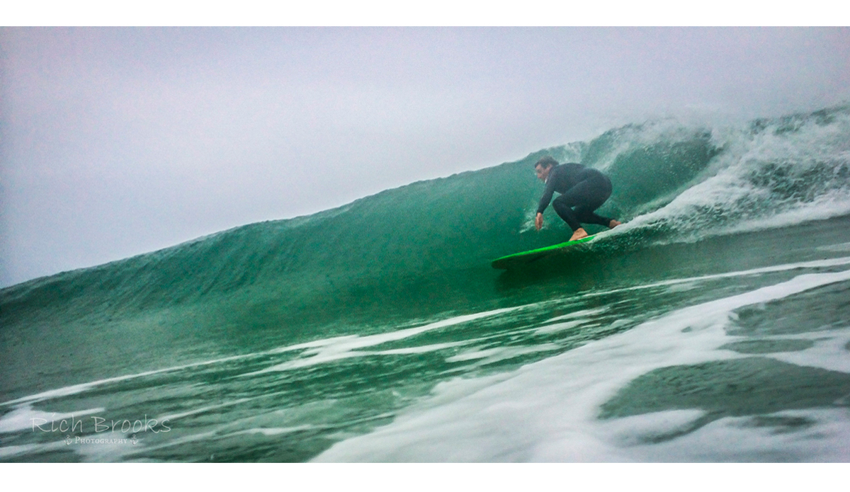 It might be gray and rainy, but Joe Gerardi is still loving the smooth glassy waves in the Gulf of Mexico. Photo: <a href=\"https://richbrooksphotography.squarespace.com/\">Rich Brooks</a>