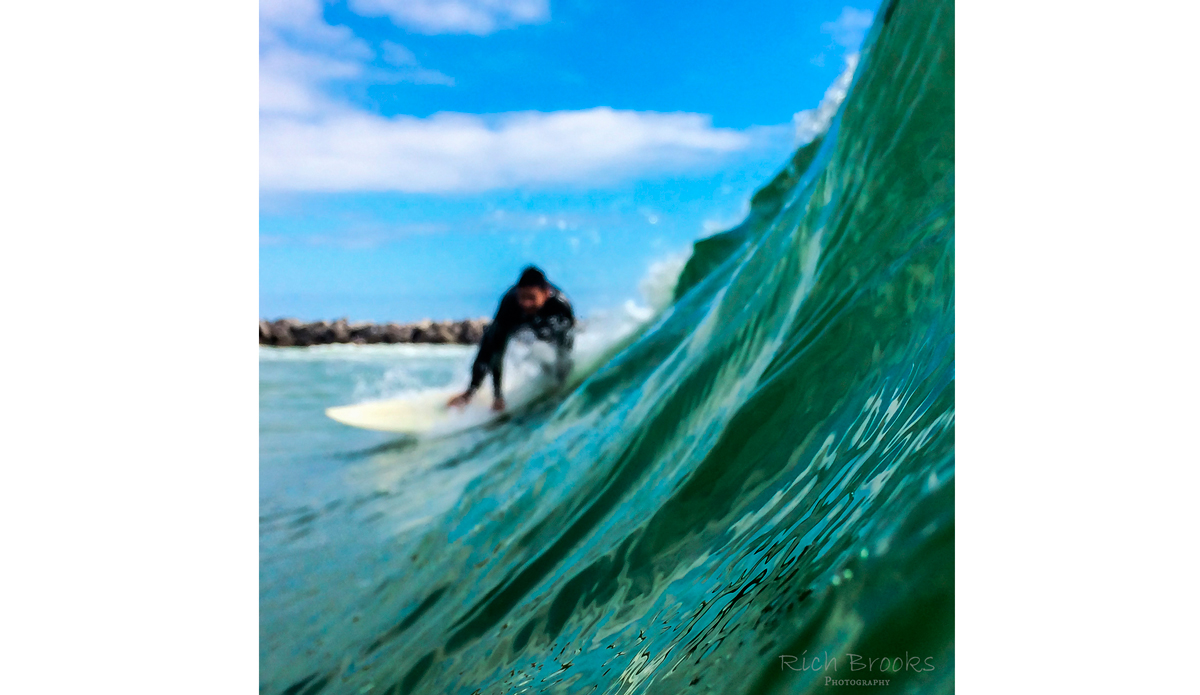 Surfer turning away from the jetty at St. Andrew\'s State Park. Photo: <a href=\"https://richbrooksphotography.squarespace.com/\">Rich Brooks</a>