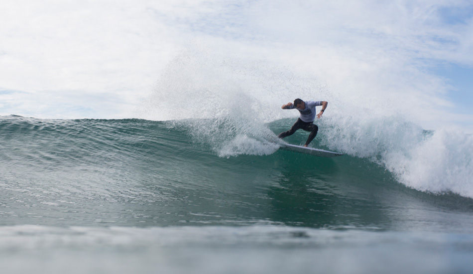 Unknown surfer laying on the rail. Photo: <a href=\"https://www.nickliotta.com\">Nick Liotta</a>