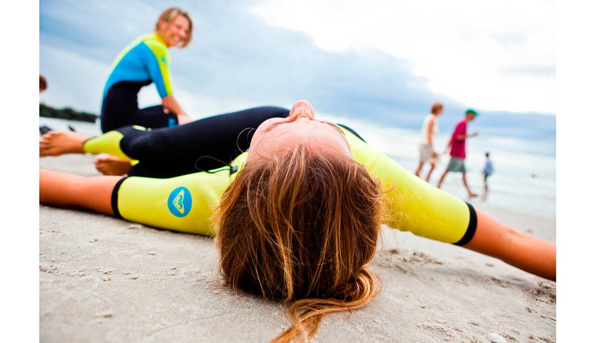 This is an image of Sally Fitzgibbons warming before paddling out with Torah Bright at the Quiksilver Pro New York in 2011. I was hired by Roxy to shoot all of their events and promo stuff at the suggestion of my friend Nick Zegel, who threw my name into the mix of photogs to consider hiring. I was in heaven. Jenny Pham and the whole crew at Roxy were so easy to work with. Not only because because I was shooting the beauties that the Roxy surf team is, but because I was doing what I loved: documenting surfing. I was seriously living the dream that week. Photo: <a href=\"https://www.ryanstruck.com/\"> Ryan Struck</a>