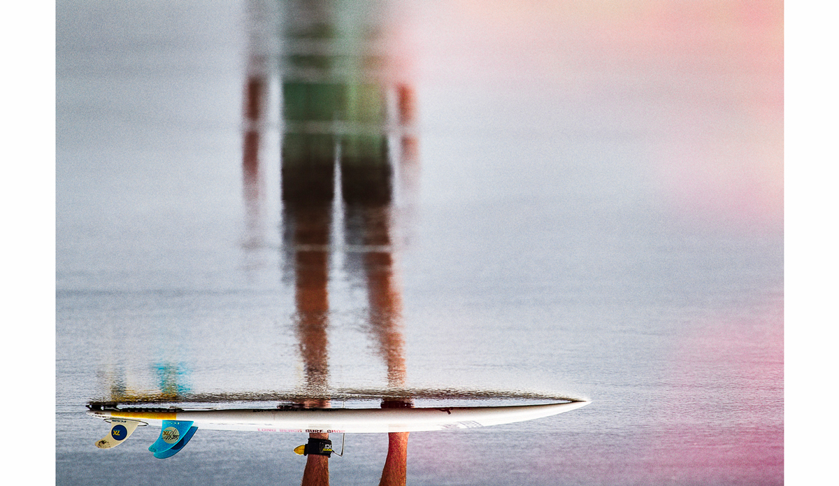 Surf board and surfer. Nicaragua. Photo: <a href=\"https://scottserfas.com/\">Scott Serfas</a>