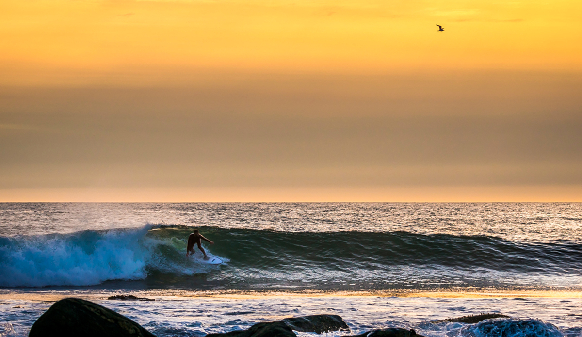 Kicking off. Riding. Blinded and focused. Looking for what we cannot see.
Sundown tickles the waves, keeping them alive while the burning light is warming faces and softening emotions. Purple water. Dusk. Hot hearted, cool watered. Light is never here to stay. Photo: Photo: <a href=\"https://www.fjordlapsephotography.com/\">Fjordlapse Photography</a>