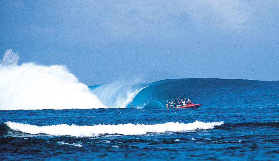 We were there on a Rip Curl team shoot in 2000, but our boat had a fouled fuel filter on this particular morning. We were watching Teahupoo from land, wondering what was going on out there. I found out much later that this moment which I had photographed from land was of Laird Hamilton\'s millennium wave. I could not see him because he was so far below sea level. What inspired me to shoot this image were the people raising their arms in the boat. This taught me the importance of always having your camera trained on the action, if you can, even with circumstances conspiring against you like we had with the fuel filter.  Photo: <a href=\"https://seandavey.com//\" target=_blank>Sean Davey</a>