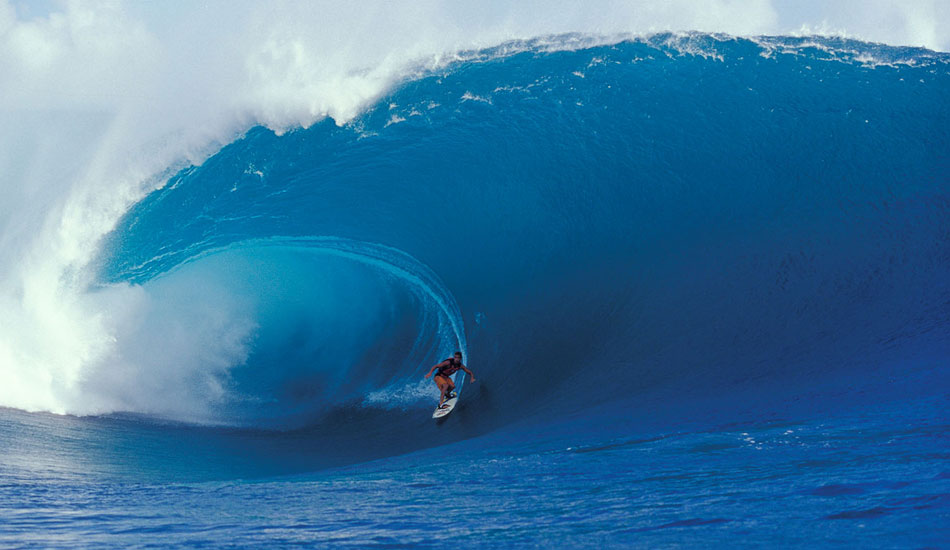 At the time, this was the biggest wave ever surfed there, and it caused quite a stir in the magazines.  What was really rad about this photo for me was that we were in a tiny little dinghy, five of us (four photog\'s and one driver). Our driver was a local surfer, very familiar with the reef at Teahupoo. He was very confident and would often have us sitting some 30 or 40 feet closer to the action than the other boats. This continually unnerved me. Then this thing came through, and I looked up at it thinking, \"we are done. There is absolutely nothing that I can do, so I will simply shoot it,\" just on the off chance that we somehow make it out of this situation. It was that serious. Scared the crap out of me, but I did get the shot. Kissed the ground when I stepped off the boat that afternoon. Moral of this story was always shoot if you can, even if it means going down in a blaze of glory, which thankfully, we didn\'t on this occasion...
Photo: <a href=\"https://seandavey.com//\" target=_blank>Sean Davey</a>