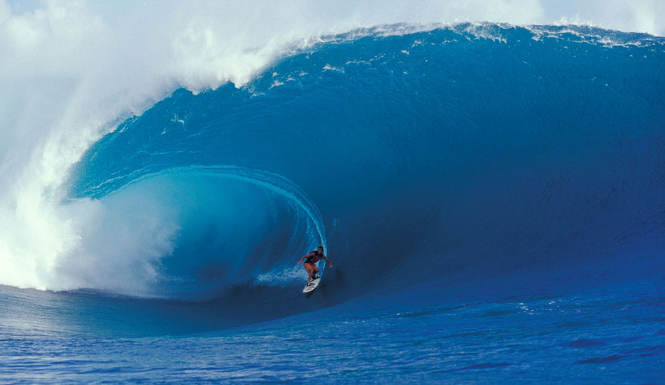 At the time, this was the biggest wave ever surfed there, and it caused quite a stir in the magazines.  What was really rad about this photo for me was that we were in a tiny little dinghy, five of us (four photog\'s and one driver). Our driver was a local surfer, very familiar with the reef at Teahupoo. He was very confident and would often have us sitting some 30 or 40 feet closer to the action than the other boats. This continually unnerved me. Then this thing came through, and I looked up at it thinking, \"we are done. There is absolutely nothing that I can do, so I will simply shoot it,\" just on the off chance that we somehow make it out of this situation. It was that serious. Scared the crap out of me, but I did get the shot. Kissed the ground when I stepped off the boat that afternoon. Moral of this story was always shoot if you can, even if it means going down in a blaze of glory, which thankfully, we didn\'t on this occasion...
Photo: <a href=\"http://seandavey.com//\" target=_blank>Sean Davey</a>