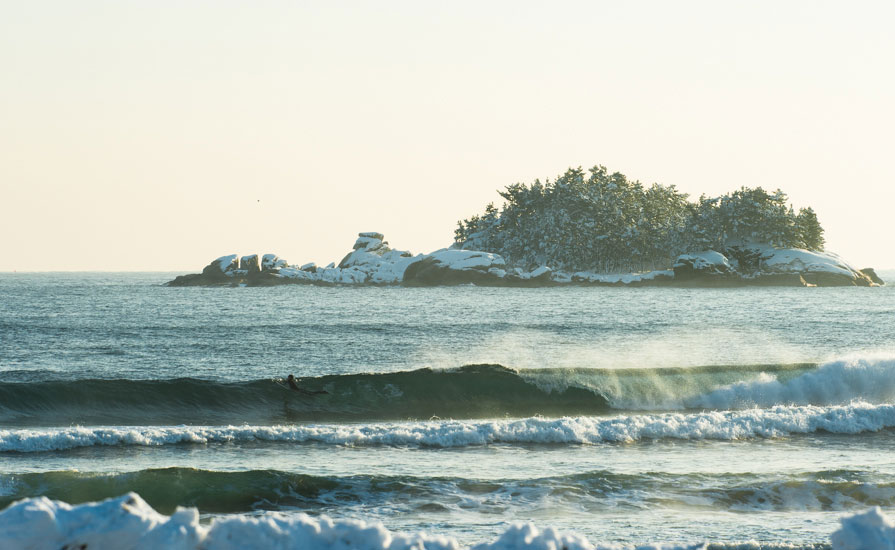 Korean surfer, Young-ik Son, looks for an early wave the day after the January snowfall. Jo-do Island is covered in snow. Photo: <a href=\"https://www.shannonaston.com/\" target=_blank>Shannon Aston</a>.