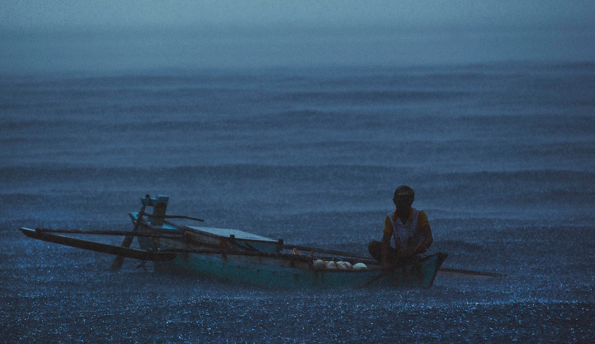 During my last trip to Indonesia we were engulfed by a huge rain squall. I noticed this dedicated shell salesman drifting alone in it until it passed. Photo: <a href=\"https://www.spencehornbyimages.com\">spencehornbyimages.com</a>