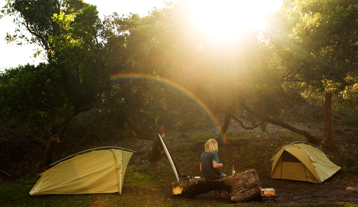 Louie Hynde post-surf beer under a cool little rainbow. Photo: <a href=\"https://www.spencehornbyimages.com\">spencehornbyimages.com</a>