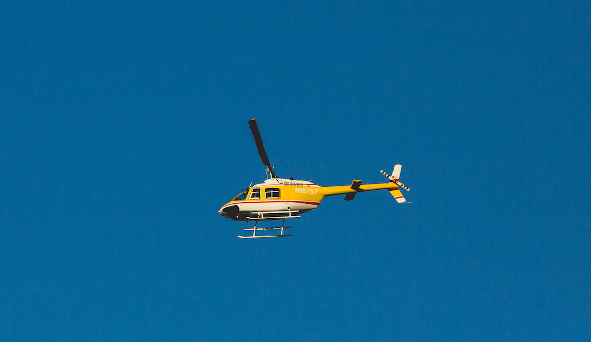 This helicopter would hover at very low altitude for a few hours every day, shooting photos of the protestors in the camp, presumably for identification purposes. Photo: Keegan Gibbs