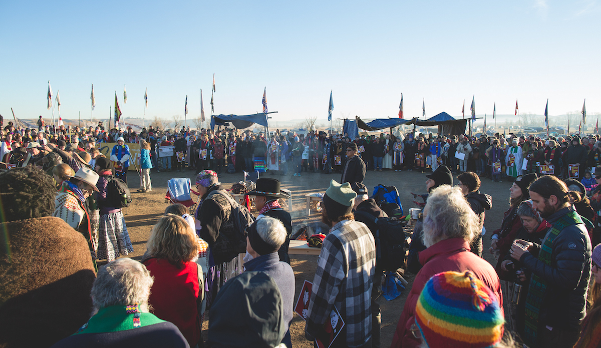 Every morning there was a meeting and prayer at the sacred fire in the middle of camp. The organization of the camp was remarkable, with first aid, daily community meetings, proper protest etiquette training, etc. Photo: Keegan Gibbs