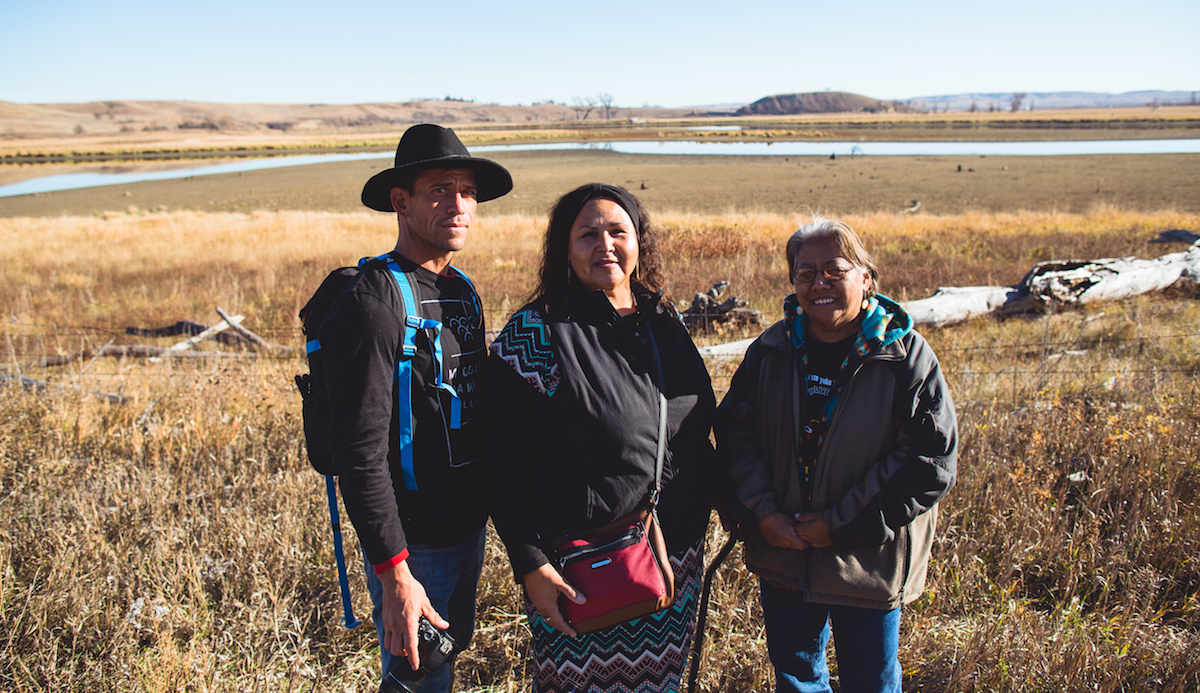 Kamalei with a couple of Native Aunties, overlooking a threatened portion of the Missouri River and sacred site for the Standing Rock Sioux tribe.  Photo: Keegan Gibbs