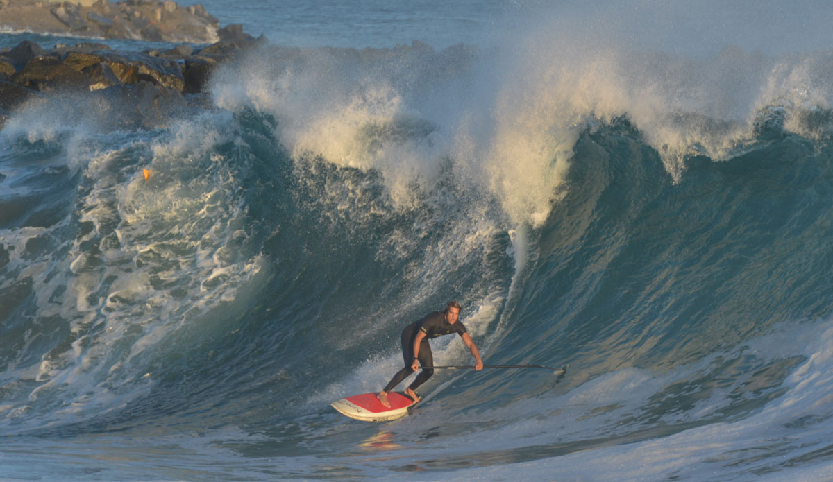 Daniel Hughes. Unfortunately, this wave ended up splitting the SUP in two. Photo: <a href=\"https://www.tylerbrundage.com/\">Tyler Brundage</a>