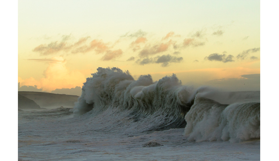 Huge backwash engulfs the Cornish fishing village of Porthleven. Photo: <a href=\"https://www.teewhyphotos.com\">Tom Young</a>