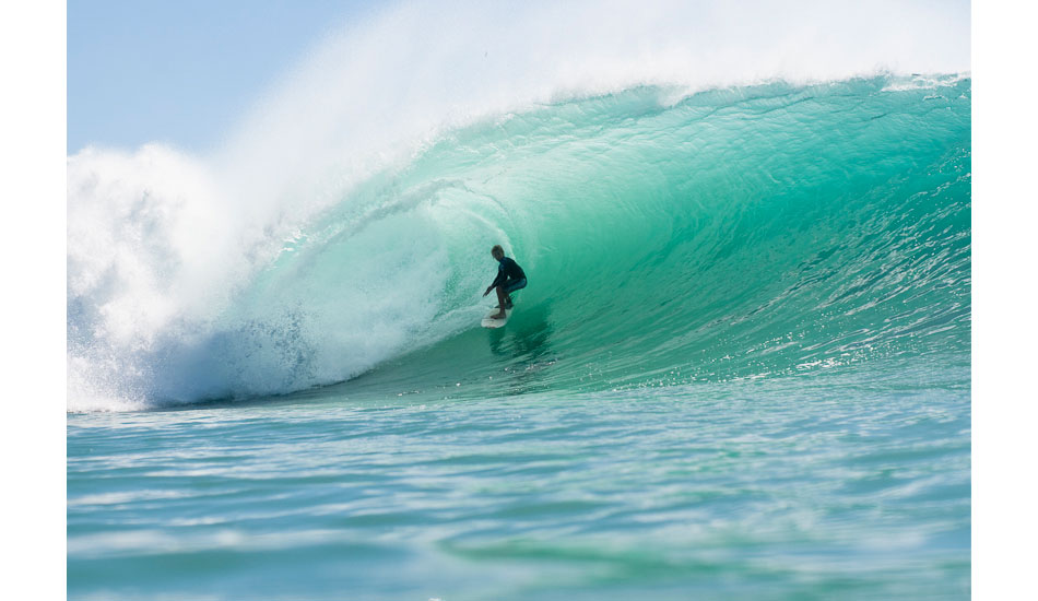 Jack Robinson tackling a Padang Padang monster on his backhand. Photo: <a href=\"https://www.teewhyphotos.com\">Tom Young</a>