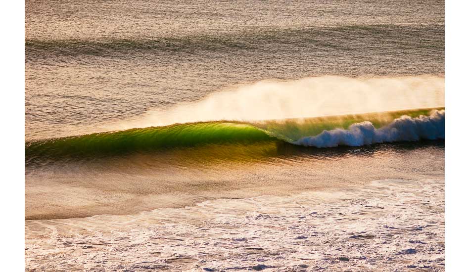 A perfect golden tube rolls through during a summer swell in South Cornwall. Photo: <a href=\"https://www.teewhyphotos.com\">Tom Young</a>
