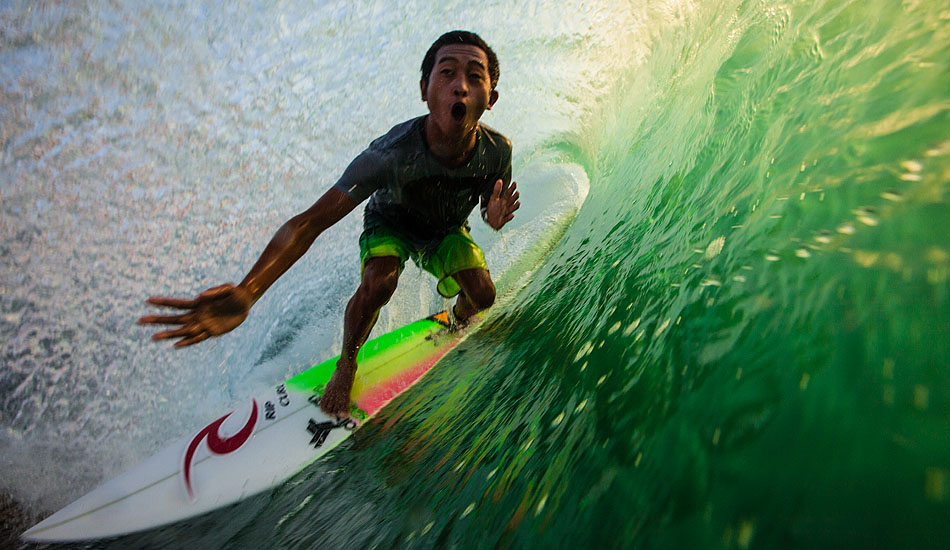 Late afternoon light on the back of a Bukit wave in Bali gives off a magical greenish glow. And if you look carefully, you might find one of the local magicians like Agus \'Dag\' spending some time in one of the island\'s legendary \'green rooms\'. Photo: <a href= \"https://tommyschultz.com/blog/category/photo-galleries/surf-photography-2/\">Tommy Schultz</a>