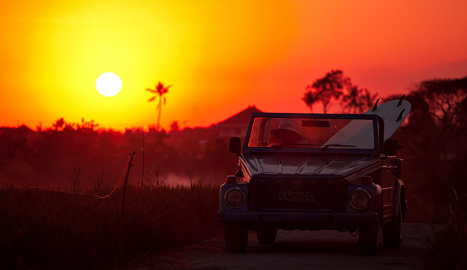 The VW bus may be the iconic surf mobile in California, but the VW \'Thing\' takes the prize in Indonesia. Bali longboarder Anders takes a shortcut through some Canggu rice terraces to catch a sunset wave. Photo: <a href= \"https://tommyschultz.com/blog/category/photo-galleries/surf-photography-2/\">Tommy Schultz</a>