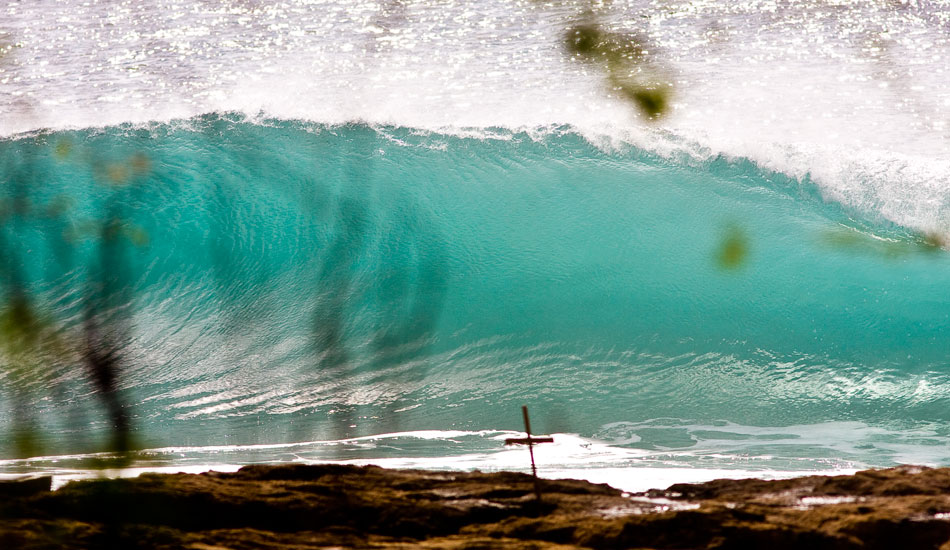 About five years ago while on the North Shore I decided to just go drive around for the day and shoot the beauty of the island. As I was driving through a certain area of the island, I looked over and saw this beautiful wave rifling off. I stopped for a few minutes and took a few lineups. Later that night, I realized the cross in the shot and was really drawn to this image. I never knew what had happened at that particular spot but the image always makes me think. Photo: <a href=\"https://tupat.posterous.com/\" target=\"_blank\">Patrick Eichstaedt</a>