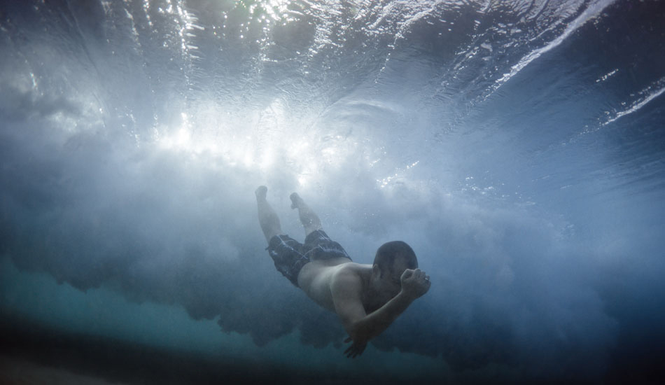 Power. A man gestures with relief after making it through the breaking wave at Bronte Beach, Sydney. “I raced to the water to shoot the last light, and in my stoke I ended up running into this guy underwater. I was looking for this angle and kept dolphining towards the swimmers behind the wave, but turning off before we hit. I wasn\'t totally paying attention on this one.” Photo: <a href=\"https://www.marktipple.com/\" target=_blank>Mark Tipple</a>.